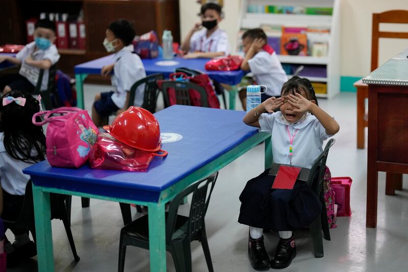 It's all too much for one girl, as the new term gets under way at San Juan Elementary School. AP Photo
