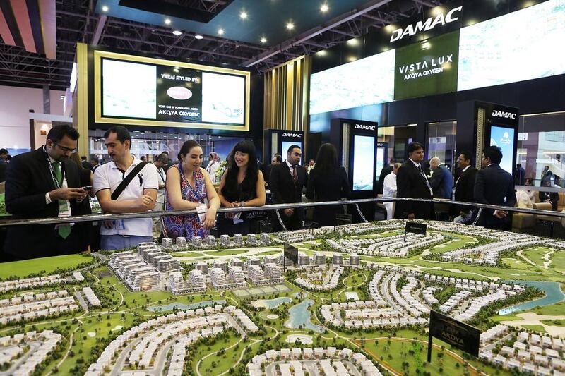 Above, the Damac stand at Cityscape Global in Dubai, which features one of its planned developments. Pawan Singh / The National