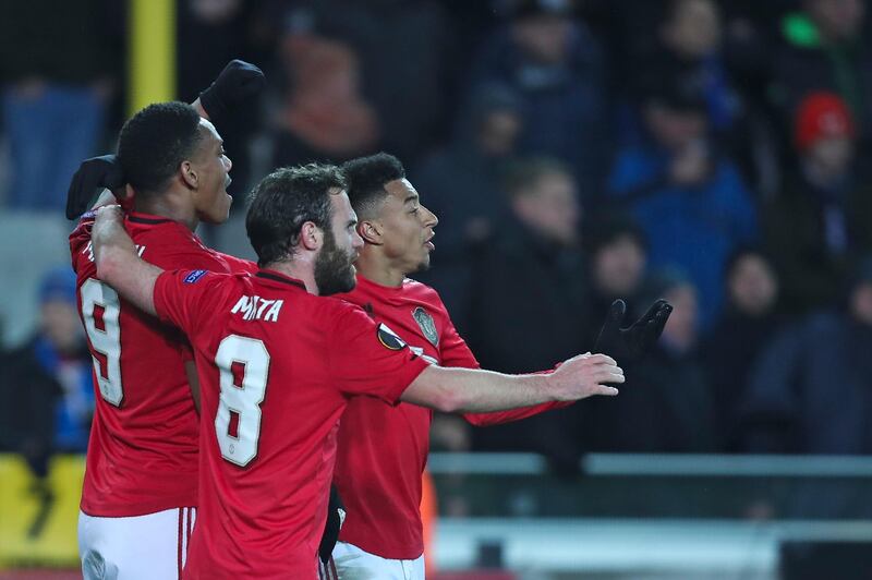 Manchester United's Anthony Martial, left, celebrates with teammates after scoring his side's first goal during the Europa League match against Brugge. AP