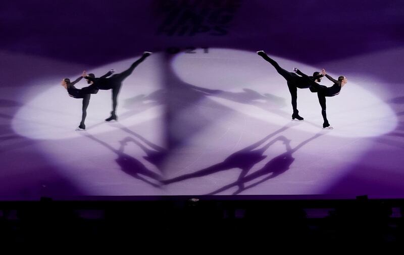 Reflected in a pane of glass, Ashley Cain-Gribble and Timothy LeDuc perform during the skating spectacular at the US Figure Skating Championships in Las Vegas. AP Photo