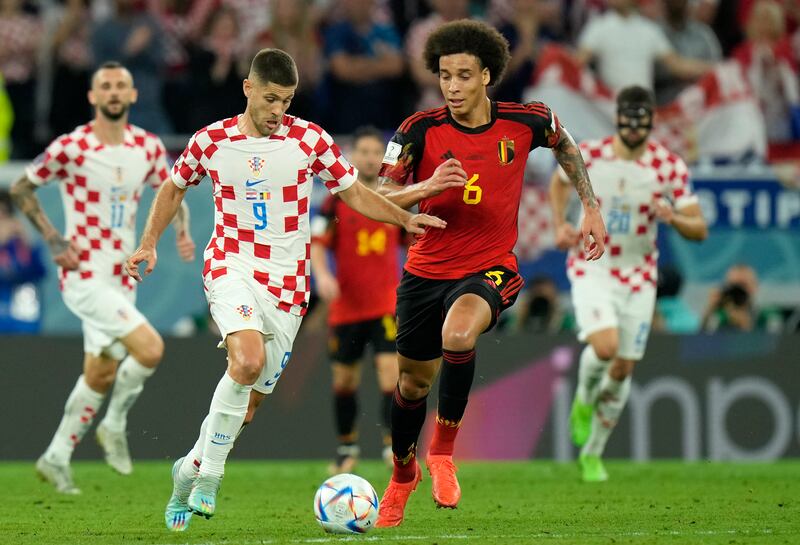 Croatia's Andrej Kramaric, left, duels for the ball with Belgium's Axel Witsel. AP