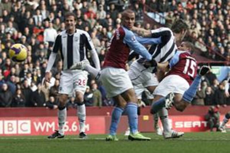 Gabriel Agbonlahor looks on as Aston Villa teammate Curtis Davies heads in the opening goal against West Bromwich Albion at Villa Park.
