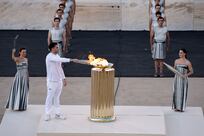 Olympic flame handed to Paris as it prepares to leave Greece on historic sailing ship