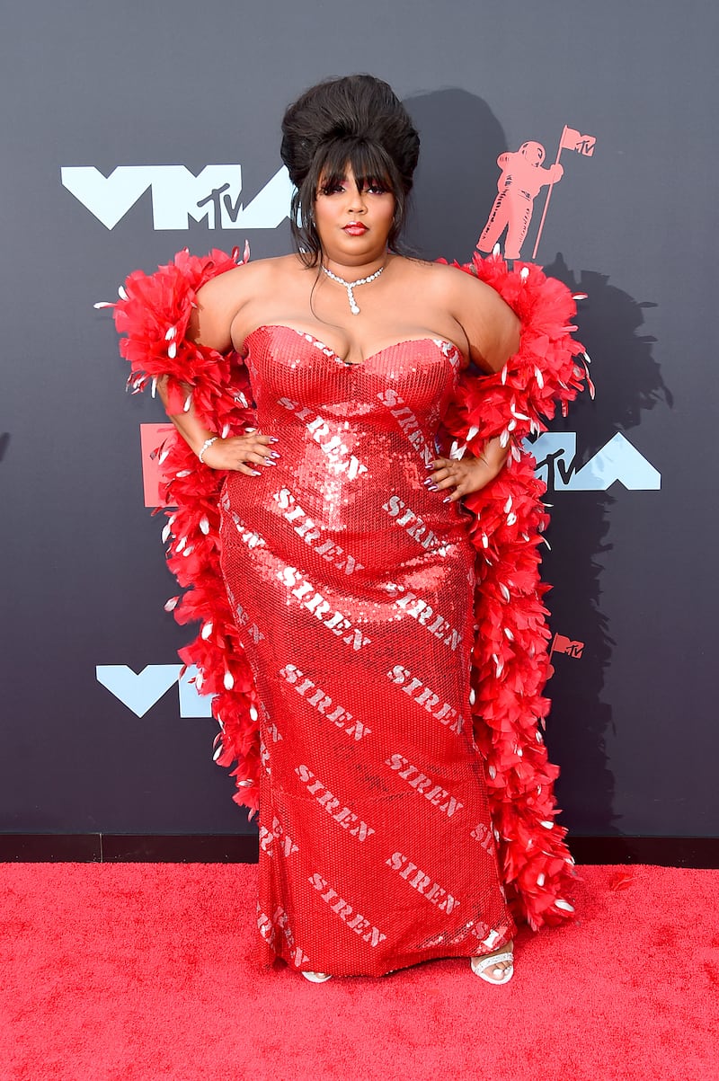 Lizzo in a strapless red sequinned gown with "siren" emblazoned on it at the 2019 MTV Video Music Awards. Getty Images