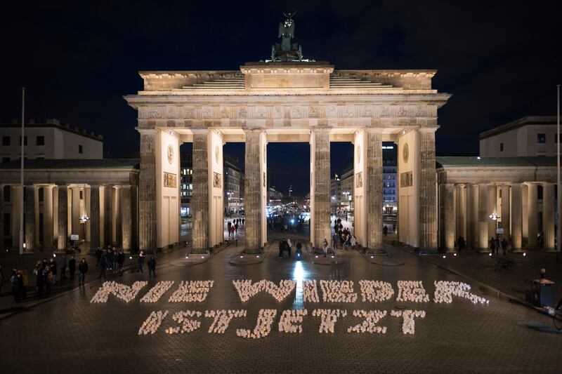 'Never again is now' is written in candles in front of the Brandenburg Gate in Berlin, Germany.  International Holocaust Remembrance Day marks the anniversary of the liberation of the Nazi concentration camp Auschwitz - Birkenau on January 27, 1945. AP Photo