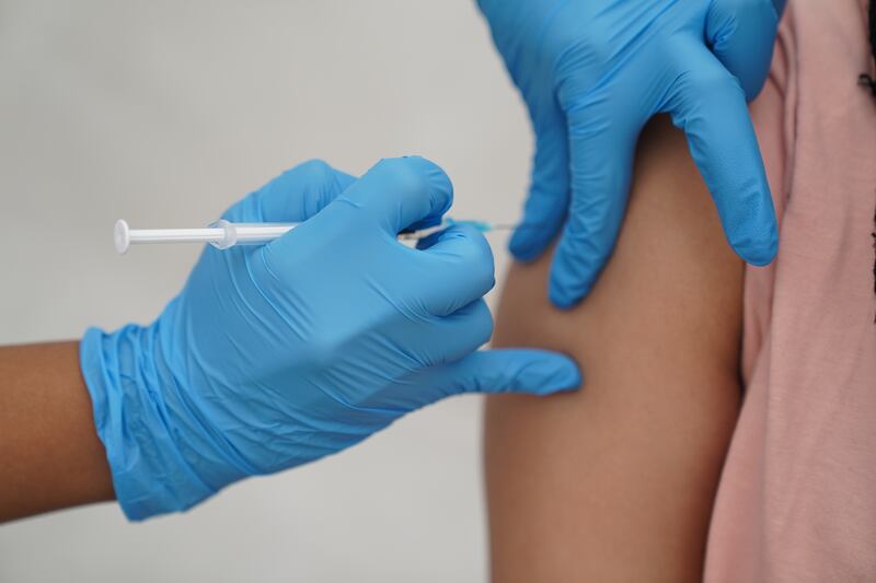 A person receives a Covid-19 vaccination. PA
