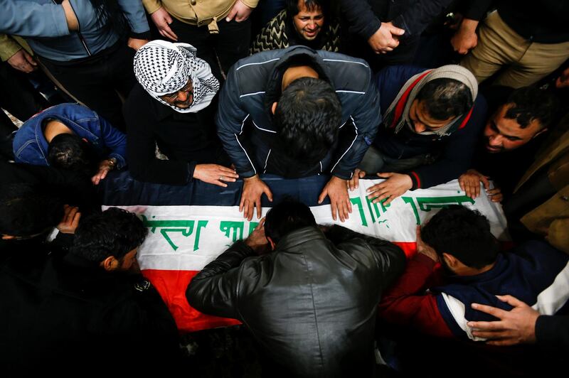 Mourners gather near the coffin of a man, who was killed in a twin suicide bombing attack in a central Baghdad market, during a funeral in Najaf, Iraq.  Reuters