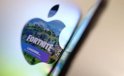 This illustration photo shows the opening screen of Epic Games’ Fortnite reflecting onto the Apple logo of the back of an I-mac in Los Angeles on  May 3, 2021. In a court clash with potentially huge repercussions for the world of mobile tech, Fortnite maker Epic Games takes on Apple starting on May 3, 2021, aiming to break the grip of the iPhone maker on its online marketplace. - 
 / AFP / Chris DELMAS
