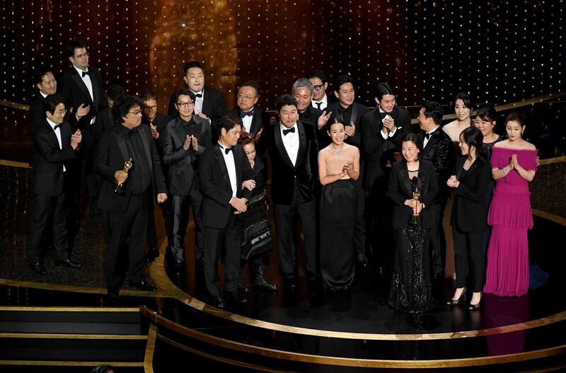 The 'Parasite' cast and crew, including such as Cho Yeo-jeong, Park So-dam, Choi Woo-shik, Kang-Ho Song,Yang Jin-mo, Jin Won Han, Kwak Sin-ae, Ha-jun Lee, Yang-kwon Moon, Kang-ho Song, Yeo-jeong Jo, Bong Joon-ho, and Sun-kyun Lee, accept the Best Picture award onstage at the 92nd Annual Academy Awards. AFP