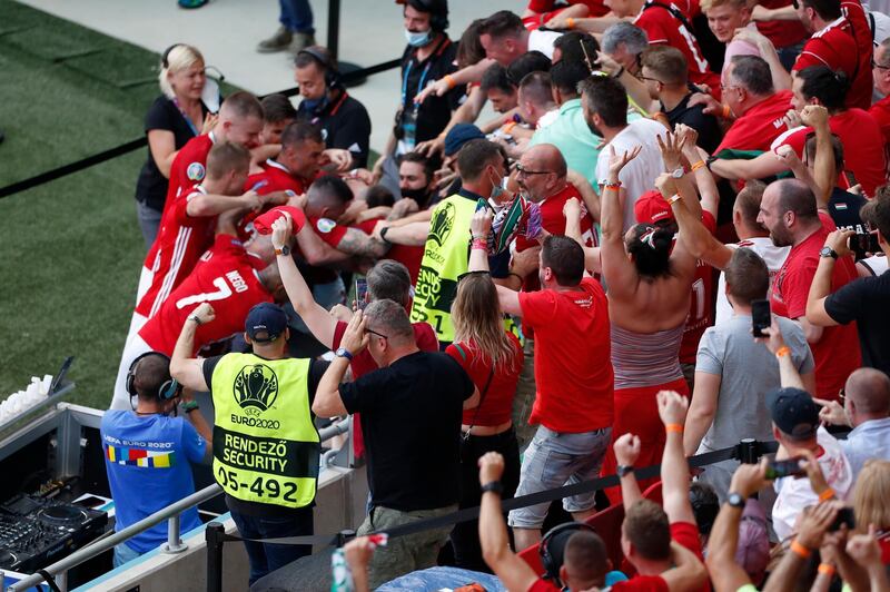 Hungary players celebrate Attila Fiola's goal with fans. Getty