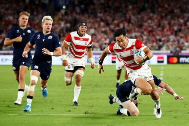 YOKOHAMA, JAPAN - OCTOBER 13: Keita Inagaki of Japan evades Stuart Hogg of Scotland to score their third try during the Rugby World Cup 2019 Group A game between Japan and Scotland at International Stadium Yokohama on October 13, 2019 in Yokohama, Kanagawa, Japan. (Photo by Stu Forster/Getty Images)