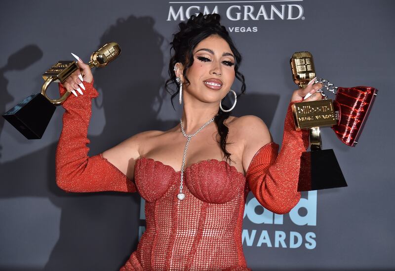 Kali Uchis poses in the press room with the awards for Top Latin Artist and Top Latin Female Artist. AP