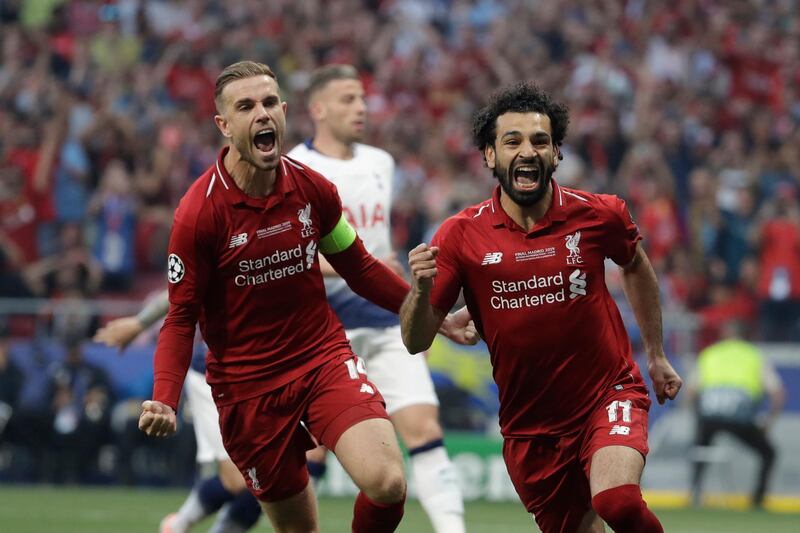 Salah, right, celebrates after scoring his side's opening goal. AP Photo