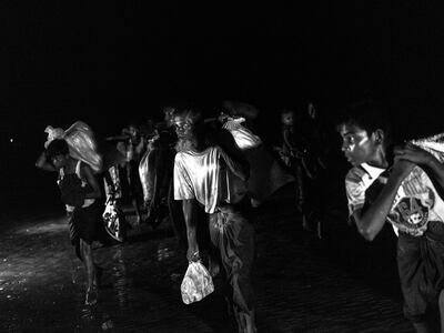 Rohingya refugees cross the Naf River from Myanmar into Bangladesh.