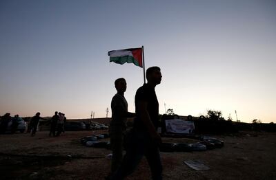 Residents of the Palestinian Bedouin village of Khan al-Ahmar, east of Jerusalem in the occupied West Bank, gather on September 26, 2018 to display support to Palestinian leader Mahmud Abbas on the eve of his speech at the United Nations General Assembly.   / AFP / ABBAS MOMANI
