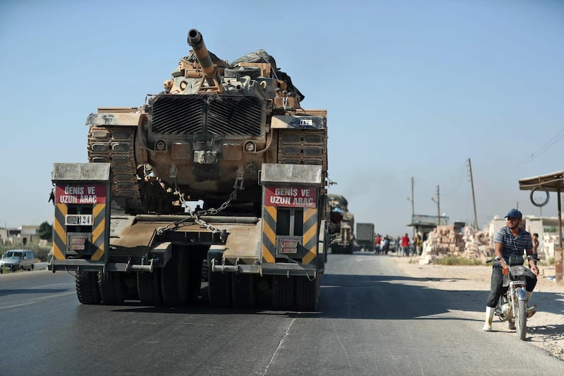 The convoy passes through the town of Saraqeb in the northwestern province of Idlib.  AFP