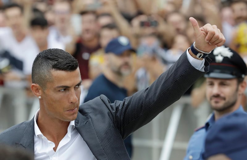 Portuguese ace Ronaldo salutes his fans as he arrives to undergo medical checks at the Juventus stadium in Turin, Italy, on July 16, 2018. AP Photo