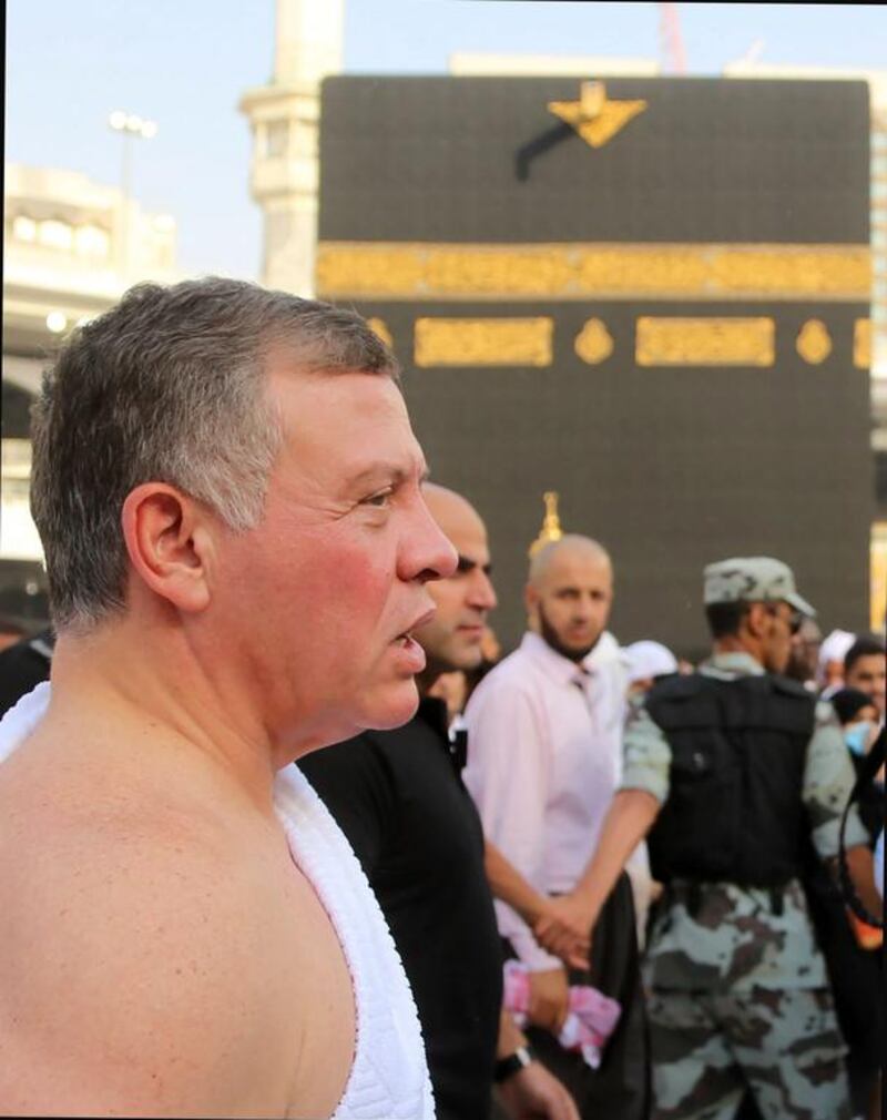 King Abdullah II stands near the Kaaba. Yousef Allan / Jordanian Royal Palace / AFP Photo