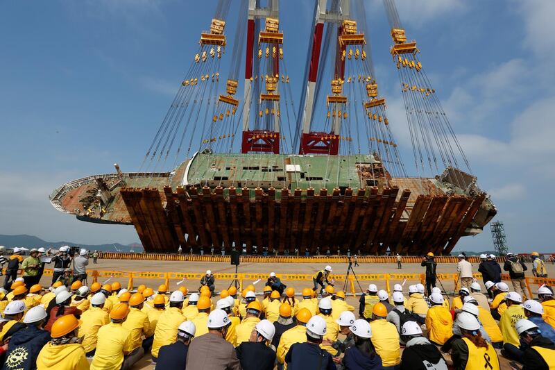 Relatives of Sewol ferry victims watch as the salvaged ferry is righted at a port in Mokpo, 410 kilometers southwest of Seoul, South Korea. Jeon Heon-Kyun / EPA