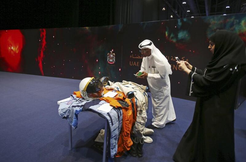 Emirati visitors take photos at the Space Museum during the launch of the UAE Space Agency strategic plan. Kamran Jebreili / AP Photo