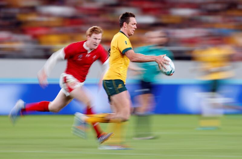 Australia's Dane Haylett-Petty in possession with Rhys Patchel of Wales about to tackle. Reuters