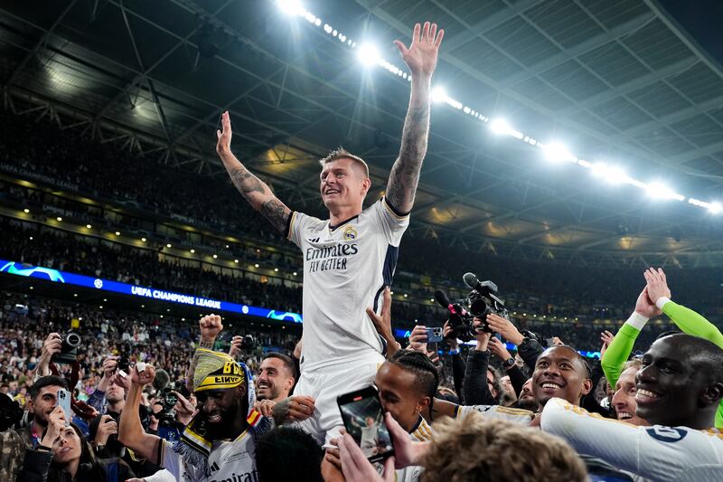 Toni Kroos is lofted onto the shoulders of his Real Madrid teammates after winning the Champions League in his final club game. PA