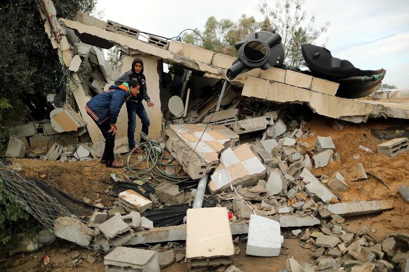Palestinians inspect the site of an Israeli air strike in Khan Younis. Reuters