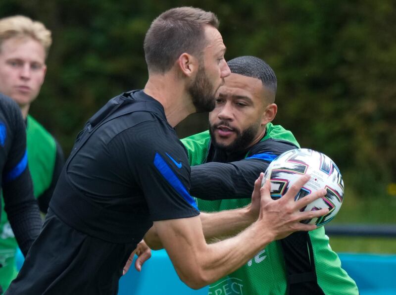 Netherlands' Stefan de Vrij, left, and Memphis Depay, right, fight for the ball during a training in Zeist before the Euro 2020 match against North Macedonia. AP