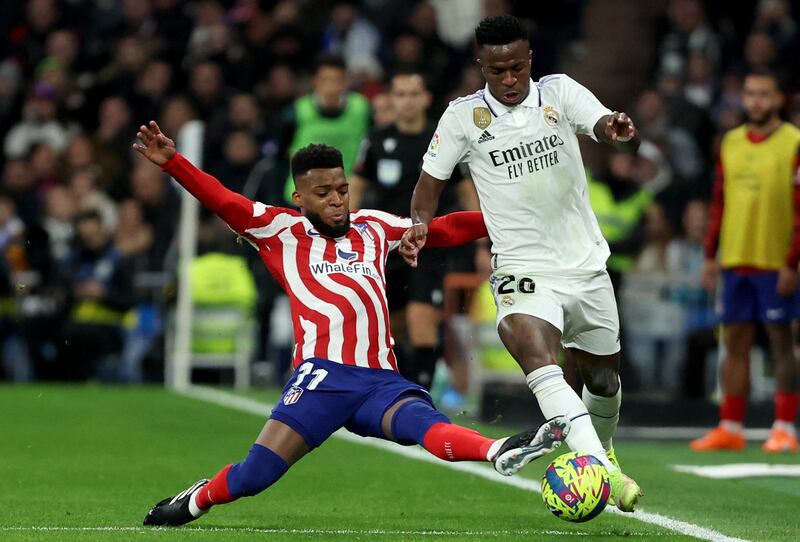Real Madrid's Brazilian forward Vinicius Junior vies with Atletico Madrid's French midfielder Thomas Lemar. AFP