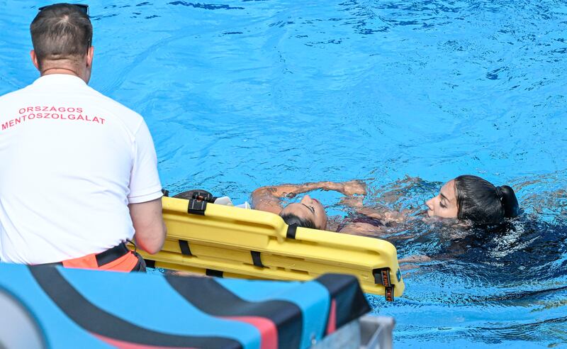 Anita Alvarez is helped from the pool after collapsing during the artistic swimming event at the World Aquatics Championships. AP