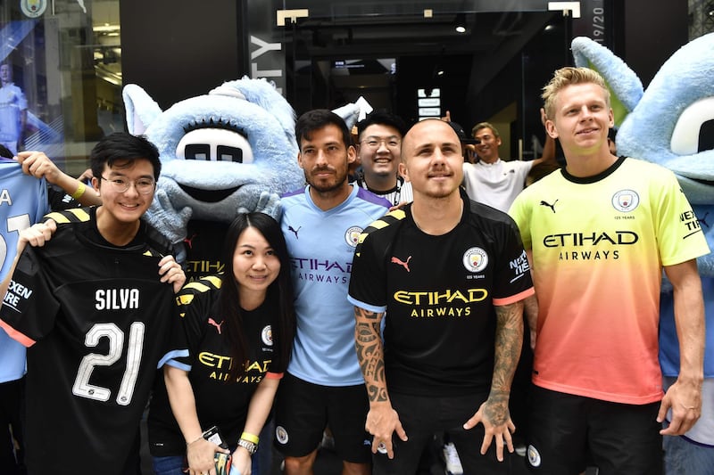 David Silva, Angelino and Oleksandr Zinchenko take pictures with fans during a promotional event in Hong Kong. Reuters
