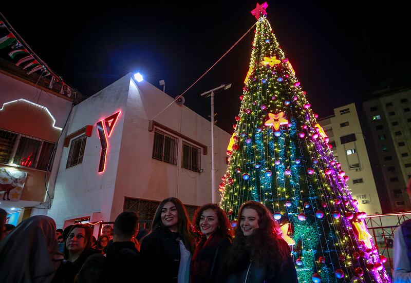 Palestinians attend a Christmas tree-lighting ceremony in Gaza city, organised by the YMCA. EPA