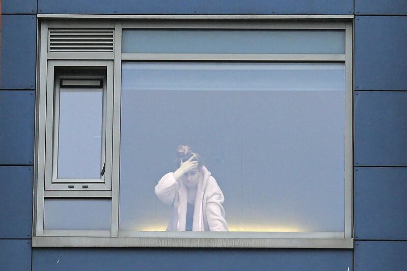 A student is seen at the window in a halls of residence for students in Northumbria University. AFP