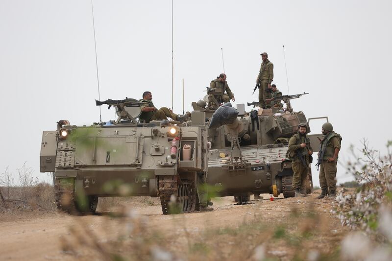 Israeli soldiers gather at an area at the border with Gaza, the scene of heavy fighting. EPA