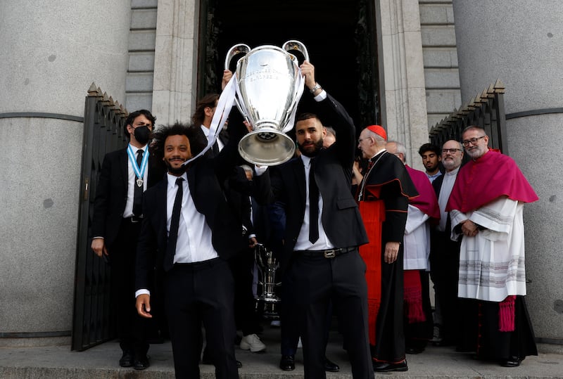 Karim Benzema and Marcelo carry the Champions League trophy at at Catedral de la Almudena as Real Madrid celebrate  with an open top bus parade. Reuters