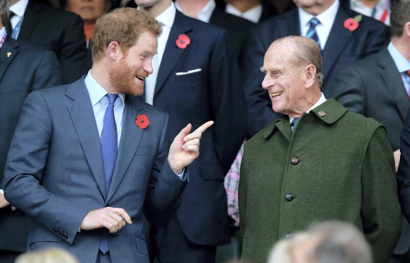 LONDON, ENGLAND - OCTOBER 31:  (EDITORS NOTE: Retransmission of #495101428 with alternate crop.) Prince Harry and Prince Phillip enjoy the atmosphere during the 2015 Rugby World Cup Final match between New Zealand and Australia at Twickenham Stadium on October 31, 2015 in London, United Kingdom.  (Photo by Phil Walter/Getty Images)