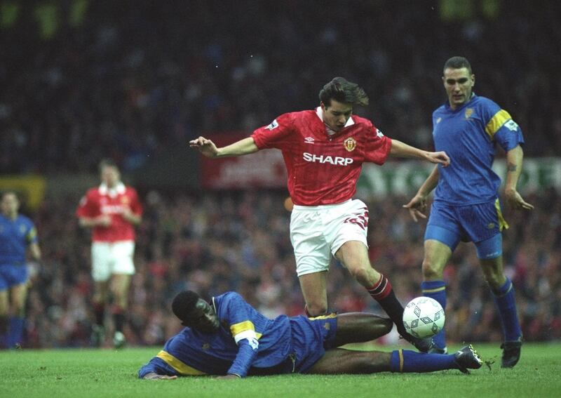 31 Oct 1992:  Robbie Earle of Wimbledon slides in to tackle Darren Ferguson of Manchester United during an FA Carling Premier League match at Old Trafford in Manchester, England. Wimbledon won the match 1-0. \ Mandatory Credit: Gary M Prior/Allsport