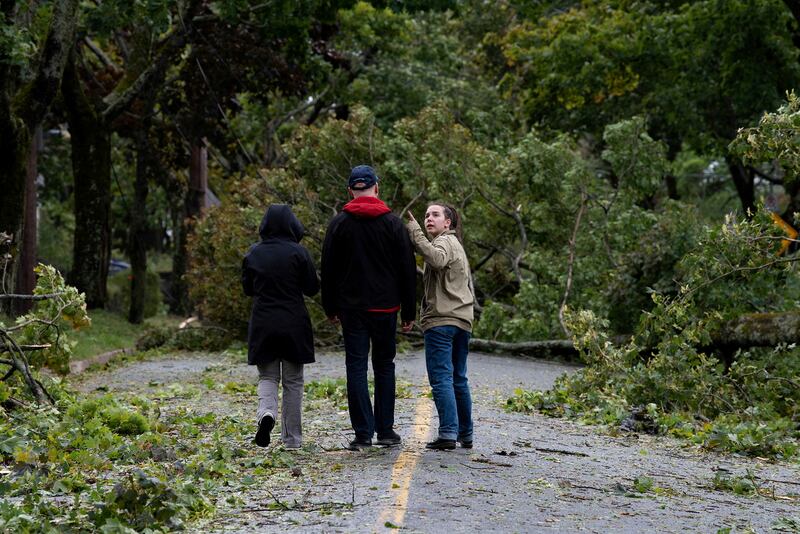 Una Rajnis points out damage as she and her parents walk around their neighbourhood to check out the wreckage following the passing of Hurricane Fiona in Halifax, Nova Scotia. Reuters