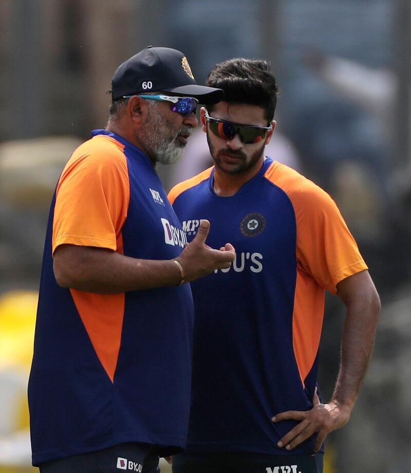 Indian bowling coach Bharat Arun, left, speaks with Shardul Thakur during a training session in Pune on Monday. AP