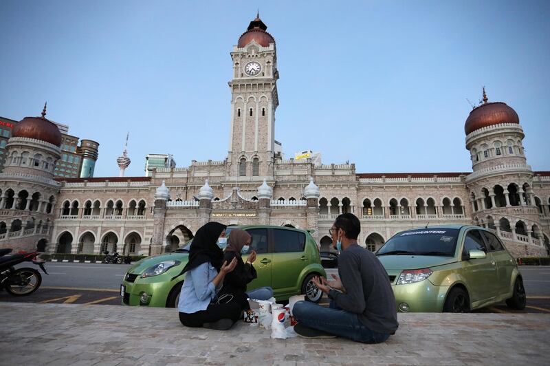 Muslims pray before breaking their fast at the end of the day during the holy month of Ramadan at Independence Square, amid the coronavirus disease (COVID-19) outbreak, in Kuala Lumpur, Malaysia May 13, 2020. REUTERS/Lim Huey Teng