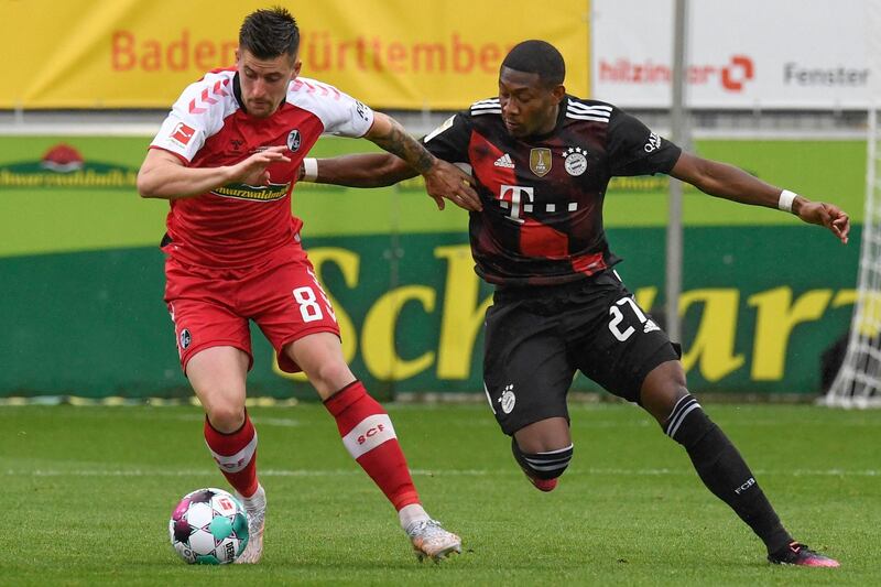 Bayern defender David Alaba challenges Baptiste Santamaria of Freiburg. AFP