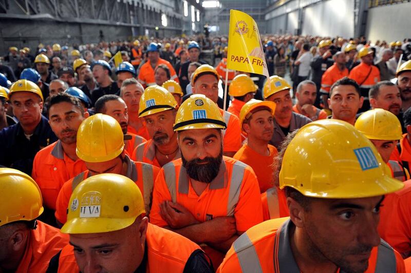 Workers from ILVA wait inside the steel plant for Pope Francis during his pastoral visit in Genoa, Italy. Giorgio Perottino / Reuters