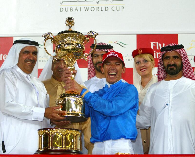 Italian rider Frankie Dettori celebrates victory at the Dubai World Cup, 29 March 2003, with Sheikh Mohammed Bin Rashed al-Maktoum (R) UAE's Minister of Defence and Crown Prince of Dubai; Sheikh Maktoum bin Rashed al-Maktoum (2nd from L), UAE's Prime Minister and ruler of Dubai; Sheikh Hamdan bin Rashed al Maktoum (L), vice ruler of Dubai and trainer Saeed Bin Suroor (3rd from L). The Dubai World Cup's seven races - five group one and two group two events - at the desert emirate's Nadi al-Sheba track are worth a combined 15.25 million dollars. AFP PHOTO/JORGE FERRARI (Photo by JORGE FERRARI / AFP)
