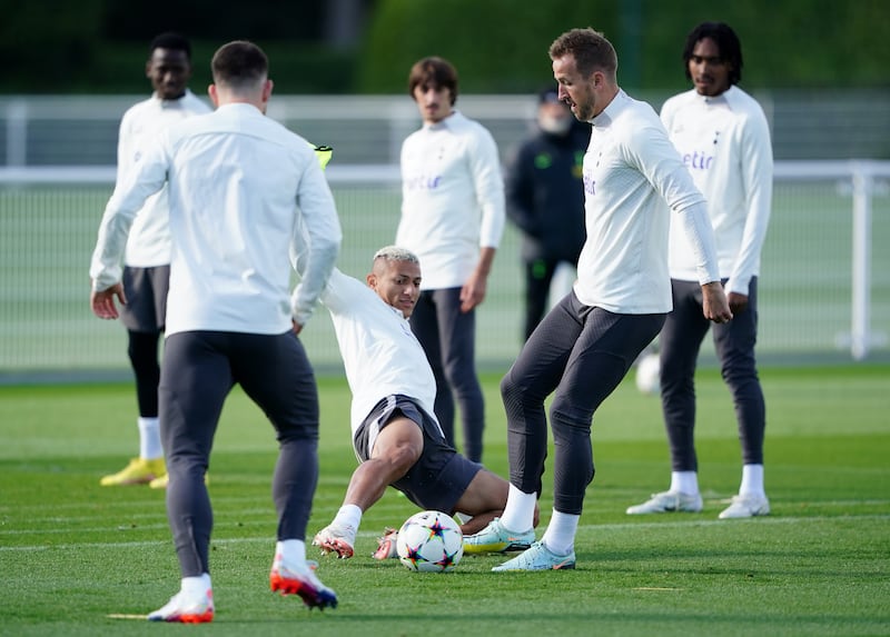 Tottenham's Harry Kane, right, and Richarlison battle for the ball during a training session. PA