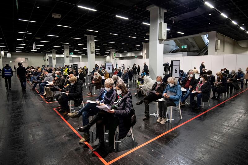 People social distance while waiting in a vaccination center in Cologne, Germany. AP Photo