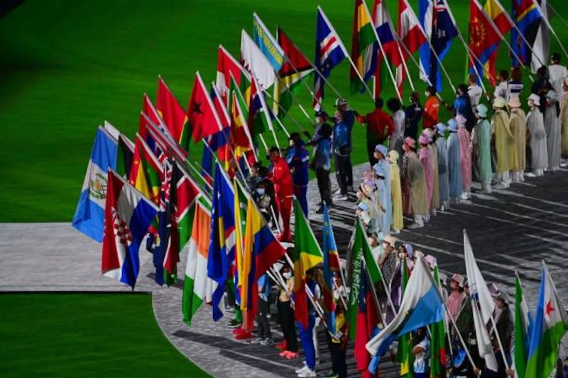 Athletes with their national flag during the closing ceremony of the 2020 Olympic Games, at the Olympic Stadium in Tokyo.
