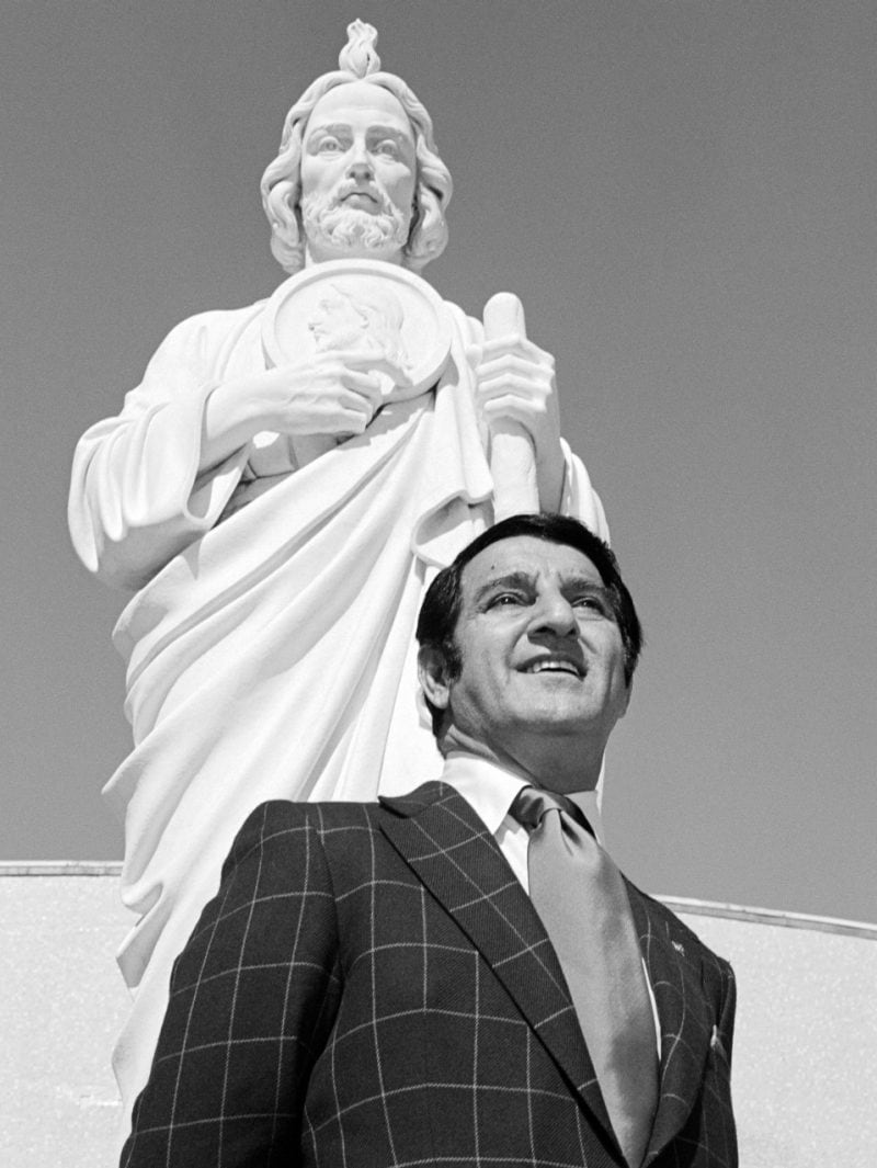 Danny Thomas stands next to a statue of St Jude Thaddeus, patron saint of hopeless causes in Catholicism