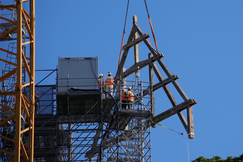 Workers position the oak frame at Notre Dame. AP