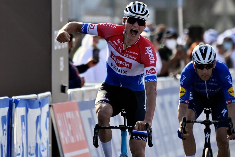 Mathieu van der Poel, of Team Alpecin–Fenix, celebrates as he approaches the finish line to win Stage 1. AP