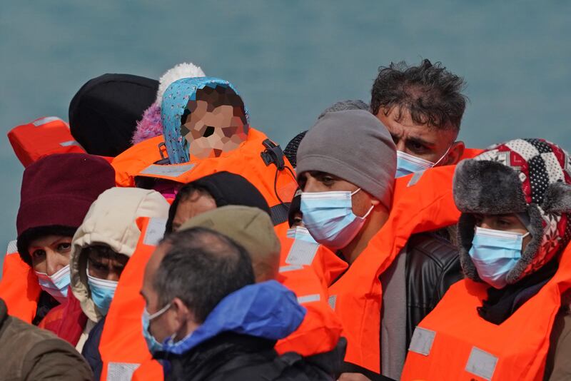 A young child is seen amongst a group of people thought to be migrants as they are brought into Dover on Thursday. PA
